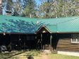 Lead image for 8779 Bingham Trail, Grayling, MI - a 1912 log cabin on the North Branch